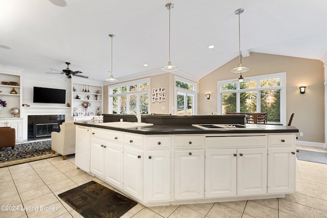 kitchen featuring lofted ceiling, a center island, pendant lighting, and white cabinets