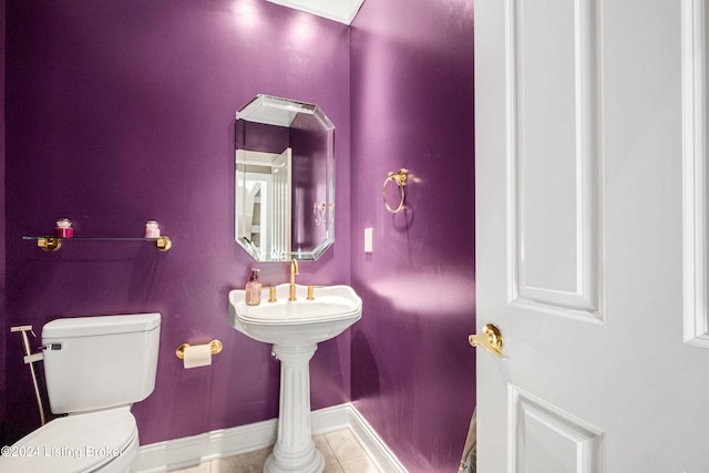 bathroom with toilet and tile patterned flooring