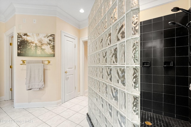 bathroom with tile patterned flooring, crown molding, and tiled shower