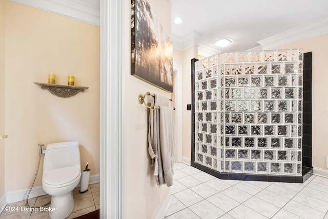 bathroom with toilet, crown molding, and tile patterned flooring