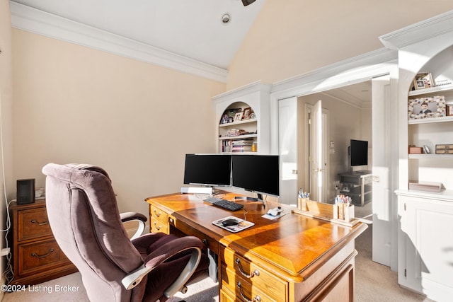 office featuring lofted ceiling, crown molding, built in shelves, and light colored carpet