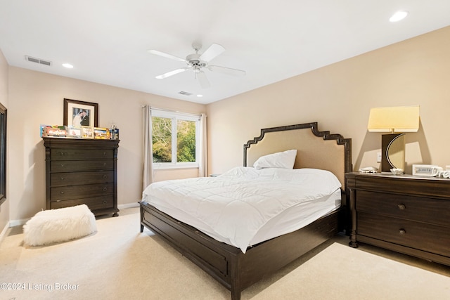 bedroom featuring light colored carpet and ceiling fan