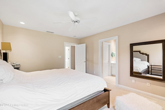 carpeted bedroom with connected bathroom and ceiling fan