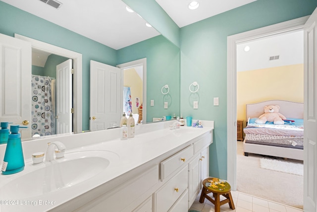 bathroom with vanity, curtained shower, and tile patterned floors