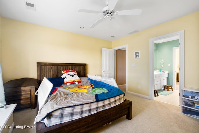 carpeted bedroom featuring connected bathroom and ceiling fan