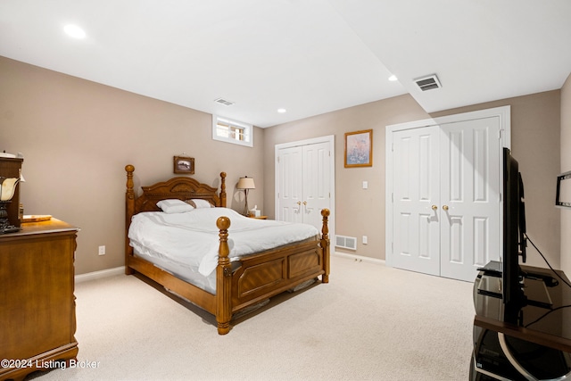 carpeted bedroom with multiple closets