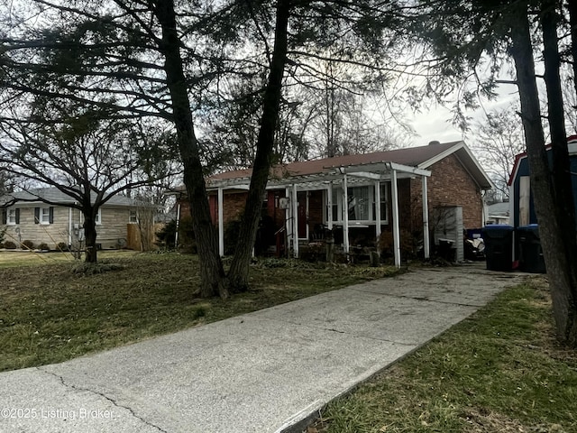 view of front of home with a pergola and a front lawn