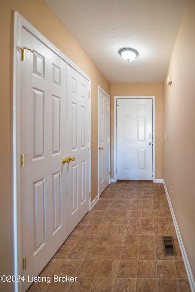 corridor featuring a textured ceiling