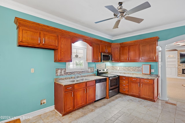 kitchen with ornate columns, crown molding, appliances with stainless steel finishes, and ceiling fan