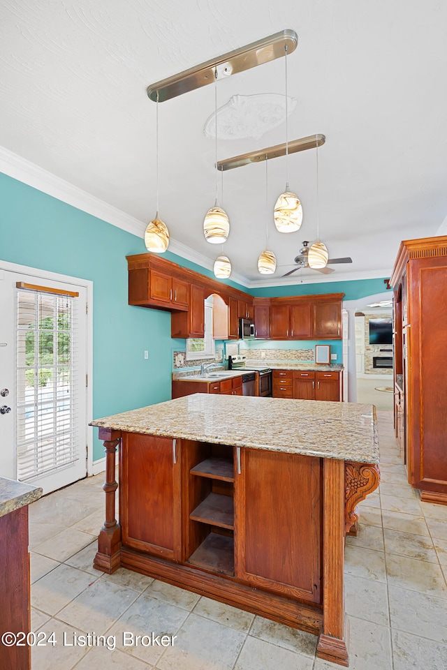 kitchen with light stone countertops, ceiling fan, stainless steel appliances, hanging light fixtures, and ornamental molding