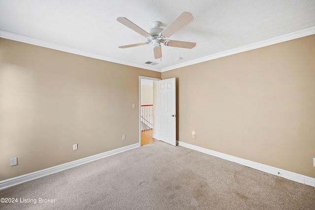 carpeted spare room with crown molding and ceiling fan