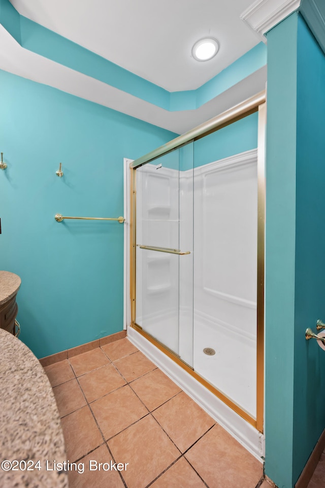 bathroom featuring an enclosed shower and tile patterned floors