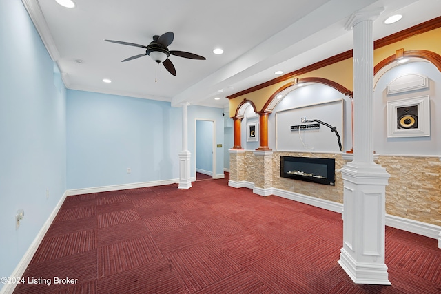 unfurnished living room with carpet floors, crown molding, and ornate columns