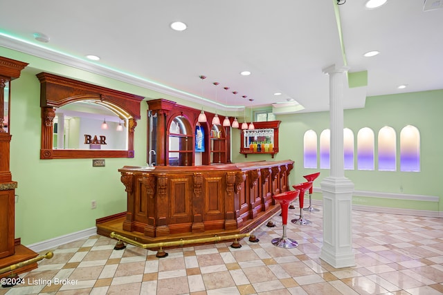 bar with ornate columns, decorative light fixtures, and light tile patterned floors