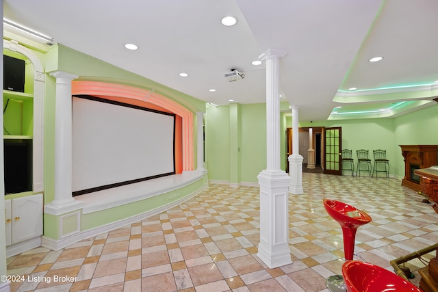 tiled home theater room featuring decorative columns