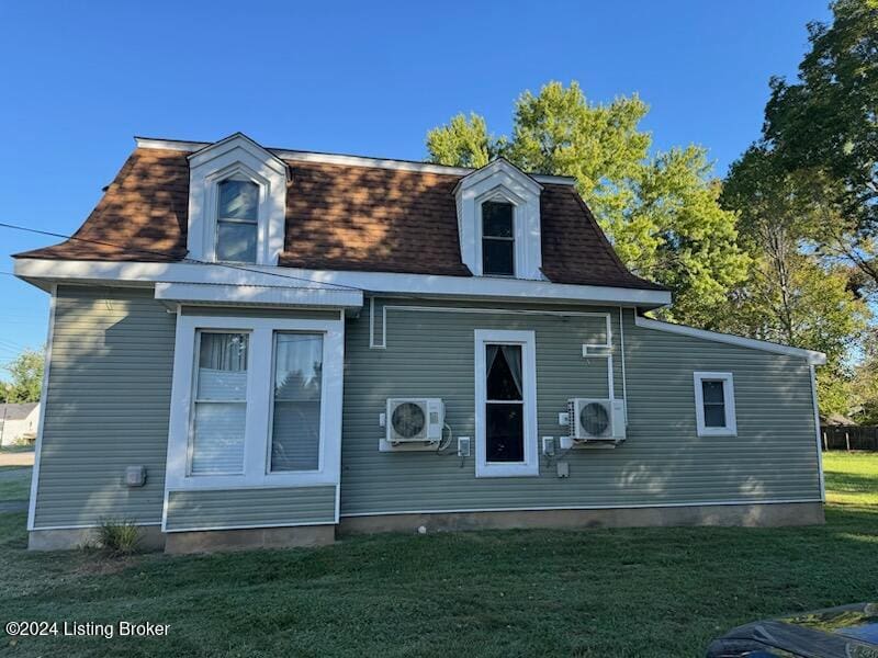 back of house with a yard and ac unit