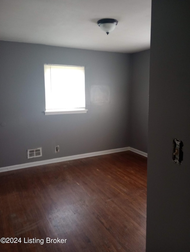 empty room featuring dark hardwood / wood-style flooring