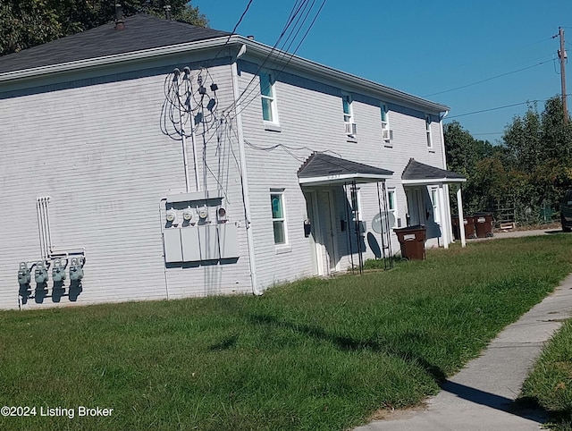 view of side of home featuring a yard