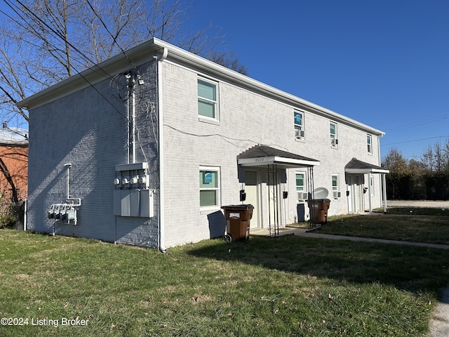 back of property with a lawn and central air condition unit