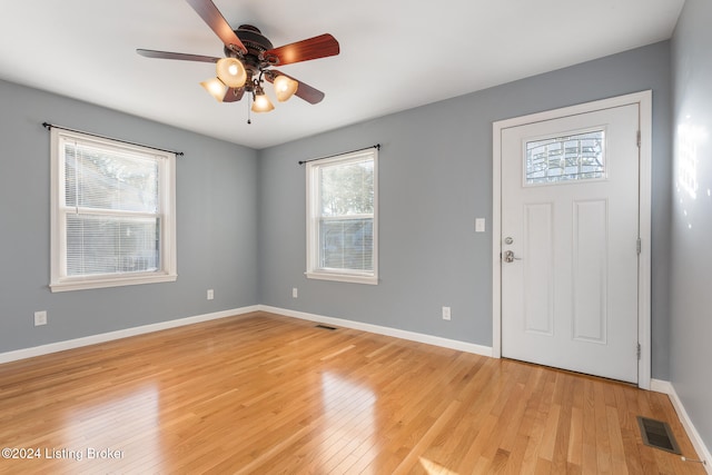 foyer with light hardwood / wood-style floors and ceiling fan