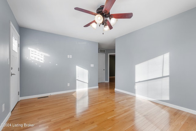 spare room featuring light wood-type flooring and ceiling fan