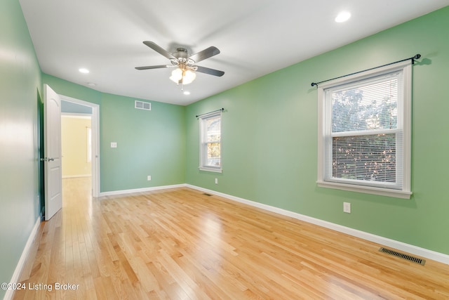 empty room with light hardwood / wood-style floors and ceiling fan