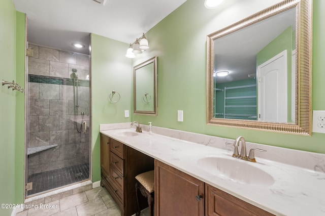 bathroom featuring vanity, tile patterned floors, and an enclosed shower