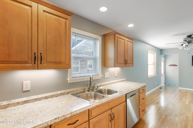 kitchen featuring dishwasher, a healthy amount of sunlight, sink, and light wood-type flooring