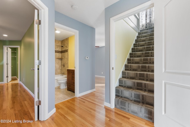 stairway with hardwood / wood-style floors