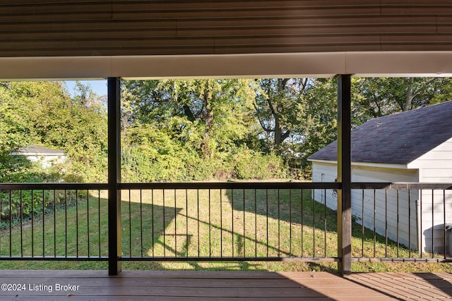 wooden deck featuring a yard