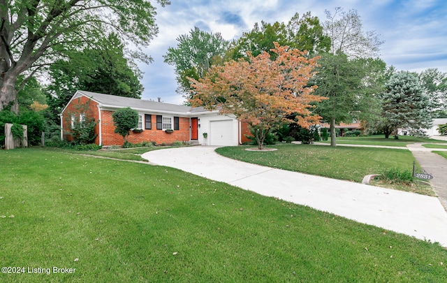 view of front of home with a garage and a front lawn