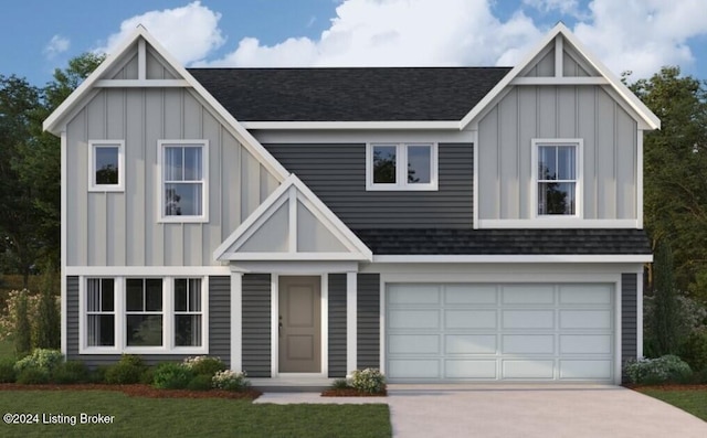 view of front of home featuring a front yard and a garage