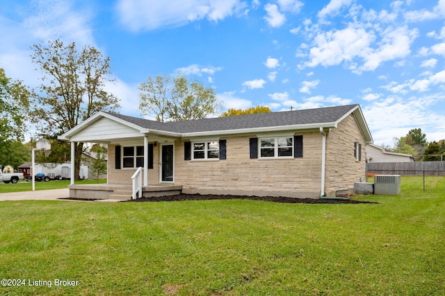 view of front of home featuring central air condition unit and a front yard