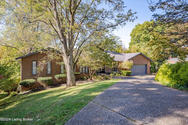 view of front of house with a front yard and a garage