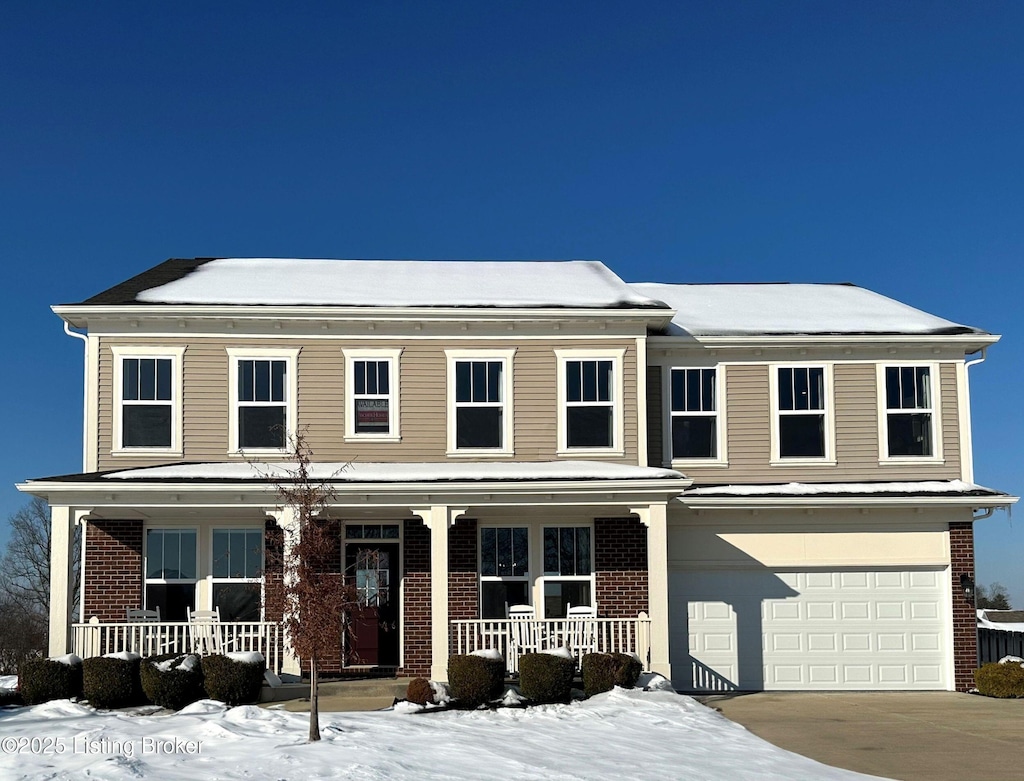 view of front of home with a garage and a porch