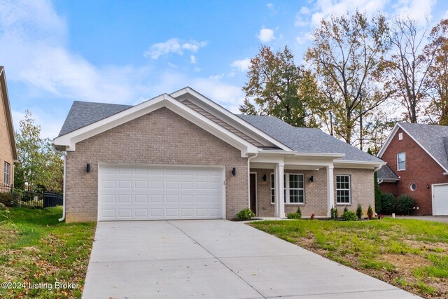 view of front of home with a garage and a front lawn