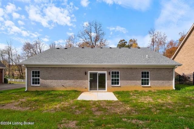 rear view of house featuring a lawn and a patio area