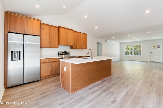 kitchen featuring stainless steel appliances, light hardwood / wood-style floors, sink, high vaulted ceiling, and a kitchen island with sink