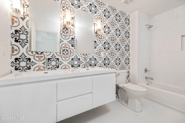 full bathroom with toilet, vanity, tiled shower / bath, and tile patterned flooring