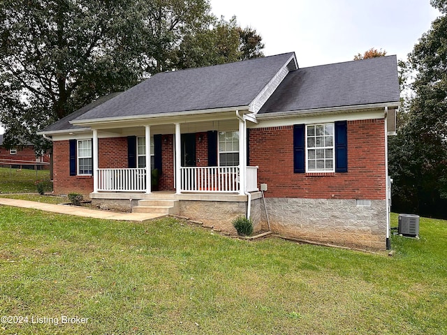 view of front of house with a porch, central air condition unit, and a front yard