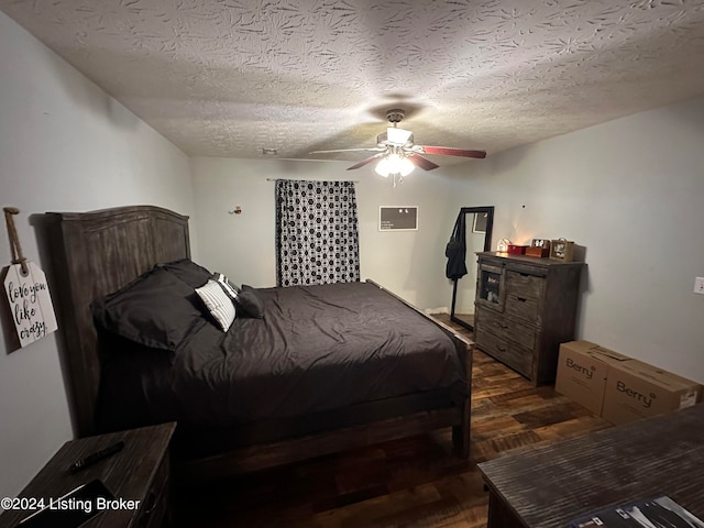 bedroom featuring ceiling fan, dark hardwood / wood-style flooring, and a textured ceiling