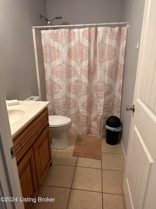 bathroom featuring a shower with curtain, vanity, tile patterned flooring, and toilet