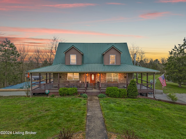 farmhouse-style home with a lawn and covered porch