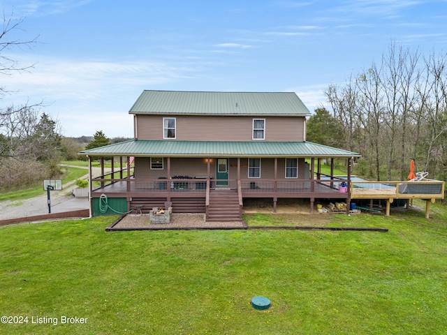 back of house featuring a lawn and covered porch