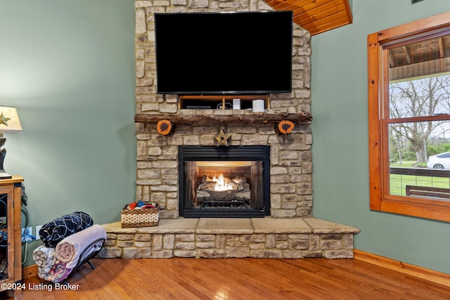 details with a stone fireplace and hardwood / wood-style floors