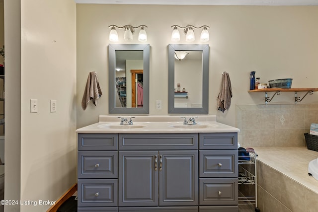 bathroom with a relaxing tiled tub and vanity