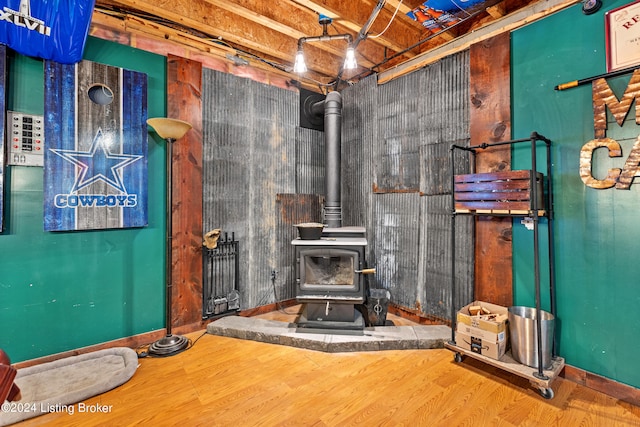 interior space featuring a wood stove and hardwood / wood-style flooring