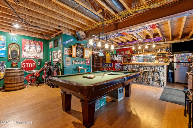 playroom featuring hardwood / wood-style flooring, pool table, and indoor bar