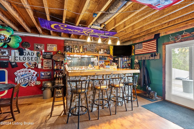 bar with wood-type flooring