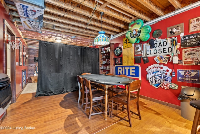 dining space with indoor bar and wood-type flooring